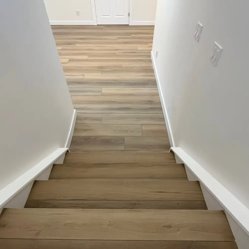 Top-down view of SPC plank staircase installation in Quebec home